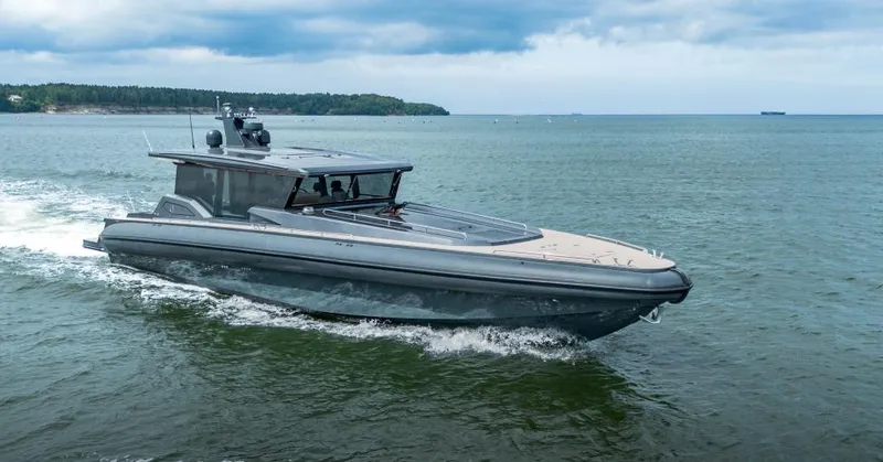 Explorer 1 Yacht Photos Pics 2024 Ridas 62 luxury boat cruising on a calm sea under a cloudy sky.