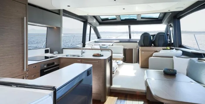  Yacht Photos Pics Luxurious interior of 2025 Princess S65 yacht with modern kitchen and seating area.