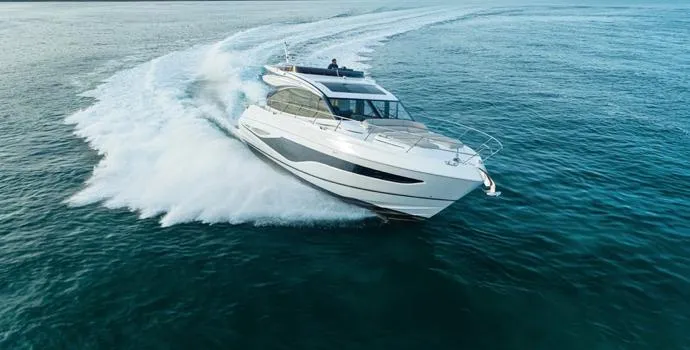  Yacht Photos Pics 2025 Princess S65 yacht cruising swiftly on open water.