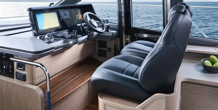  Yacht Photos Pics Luxurious 2025 Princess S65 yacht cockpit with leather seating and advanced navigation systems.