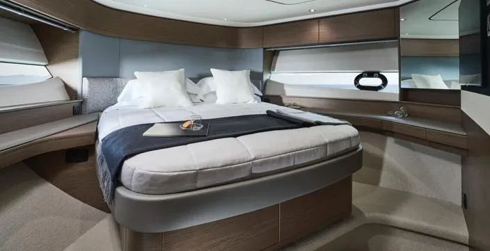  Yacht Photos Pics Luxurious bedroom interior of 2025 Princess S65 yacht with modern design and elegant furnishings.
