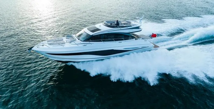  Yacht Photos Pics Luxurious 2025 Princess S65 yacht cruising swiftly on open water.