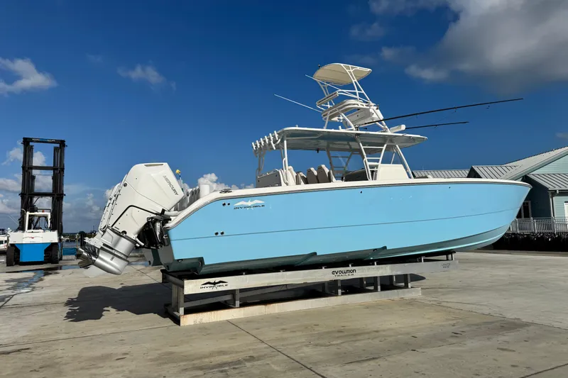  Yacht Photos Pics 2020 Invincible 40 Catamaran in light blue on dock, clear sky background.