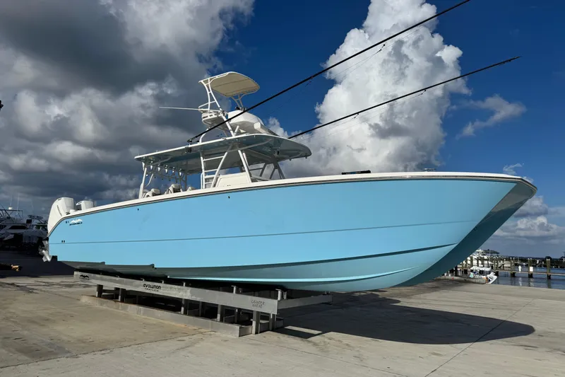  Yacht Photos Pics 2020 Invincible 40 Catamaran in light blue, docked under a cloudy sky.