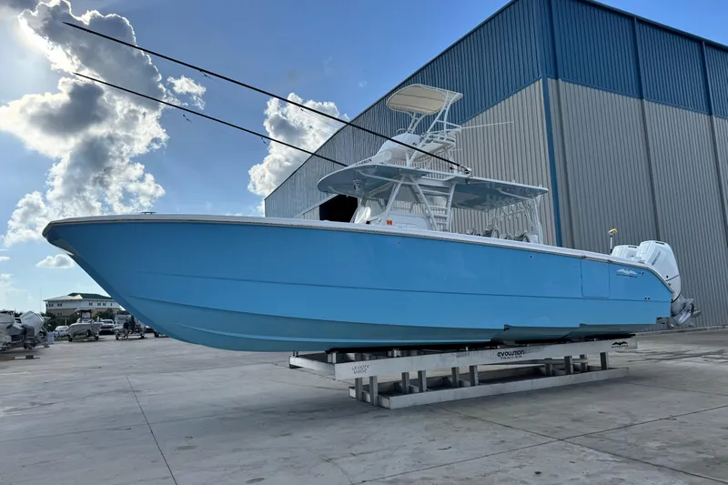  Yacht Photos Pics Blue 2020 Invincible 40 Catamaran on display outside a large warehouse.