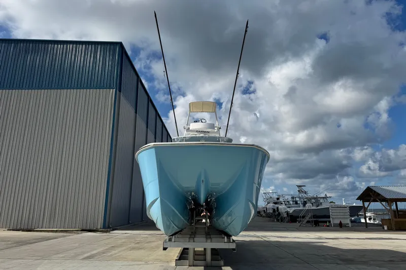  Yacht Photos Pics 2020 Invincible 40 Catamaran in boatyard, under cloudy sky, front view.