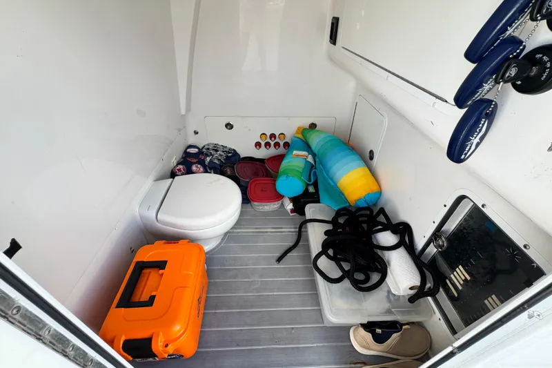  Yacht Photos Pics Interior of 2020 Invincible 40 Catamaran with toilet, storage items, and safety equipment.