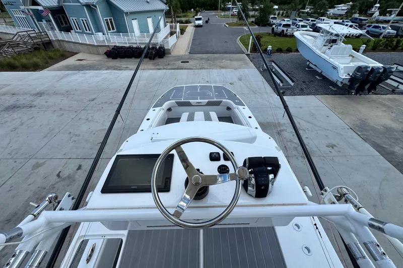  Yacht Photos Pics Invincible 40 Catamaran 2020 helm view, featuring steering wheel and control panel at marina.