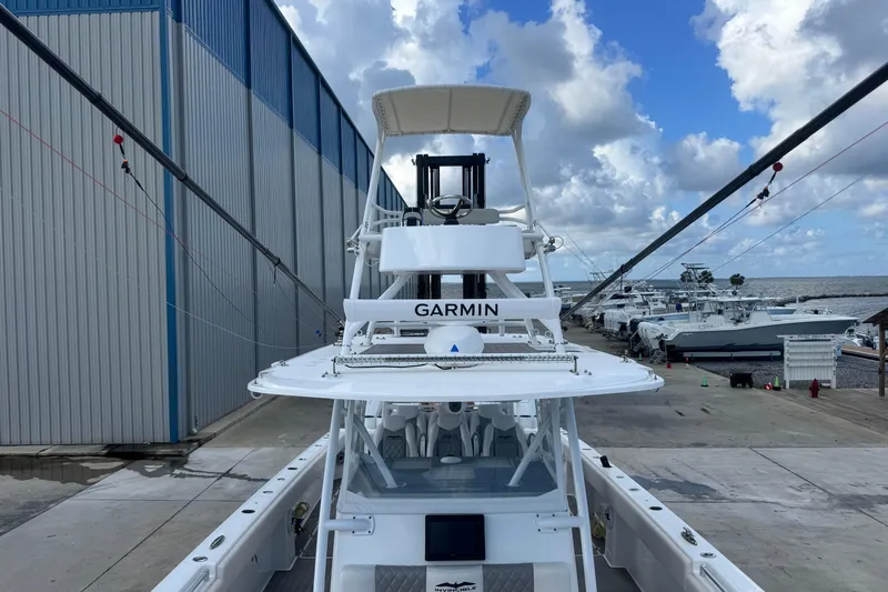  Yacht Photos Pics 2020 Invincible 40 Catamaran docked, featuring Garmin equipment, under a partly cloudy sky.