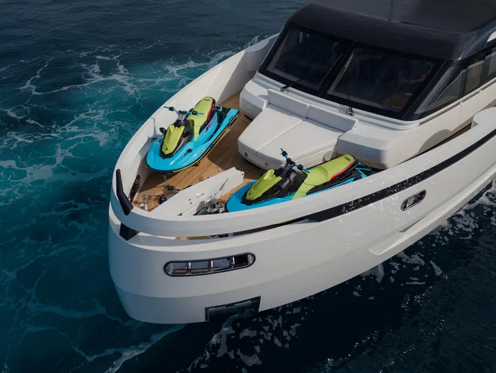 Mini K2 Yacht Photos Pics Luxury yacht Extra X99 FAST 2022 with jet skis on deck, cruising in blue ocean waters.