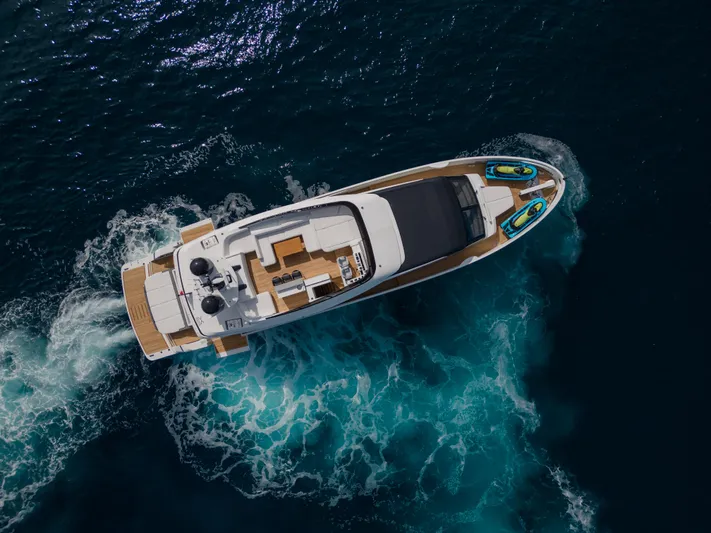 Mini K2 Yacht Photos Pics Aerial view of 2022 Extra X99 FAST yacht cruising in deep blue ocean waters.