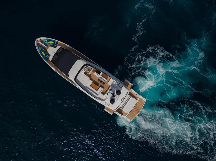 Mini K2 Yacht Photos Pics Aerial view of 2022 Extra X99 FAST yacht cruising in deep blue ocean waters.