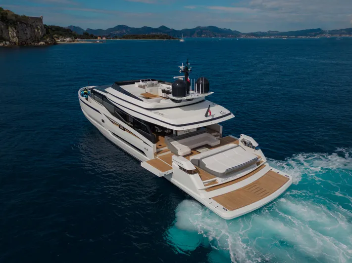 Mini K2 Yacht Photos Pics Luxury yacht Extra X99 FAST 2022 cruising in open sea, scenic coastal backdrop.