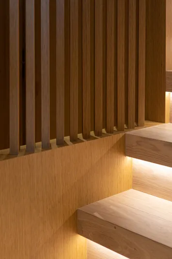 Mini K2 Yacht Photos Pics Modern wooden staircase with ambient lighting, featuring vertical slats.