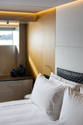 Mini K2 Yacht Photos Pics Luxurious bedroom interior on 2022 Extra X99 FAST yacht with modern design elements.