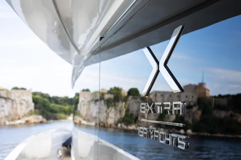 Mini K2 Yacht Photos Pics Luxury yacht Extra X99 FAST 2022 cruising near scenic cliffs.