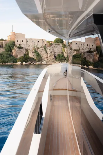 Mini K2 Yacht Photos Pics Luxury yacht Extra X99 FAST 2022 cruising near historic coastal fortress.