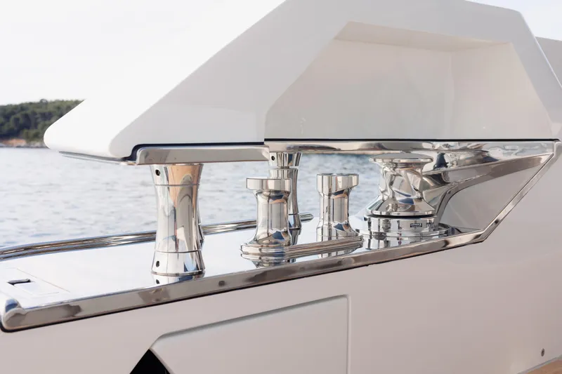 Mini K2 Yacht Photos Pics Sleek chrome fittings on a 2022 Extra X99 FAST yacht, with a serene water backdrop.