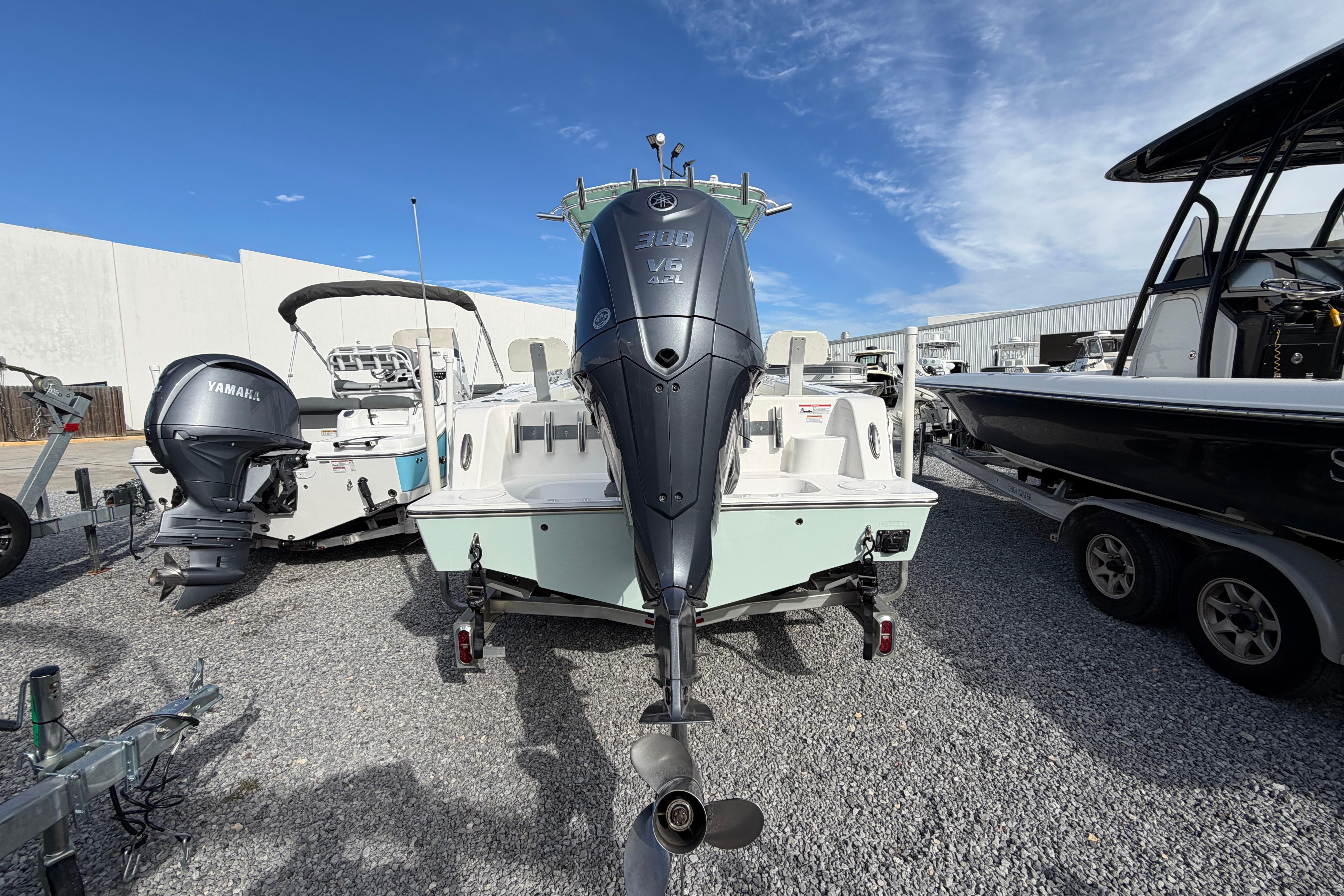 2023 Contender 24 Sport boat with Yamaha outboard motor, displayed outdoors.