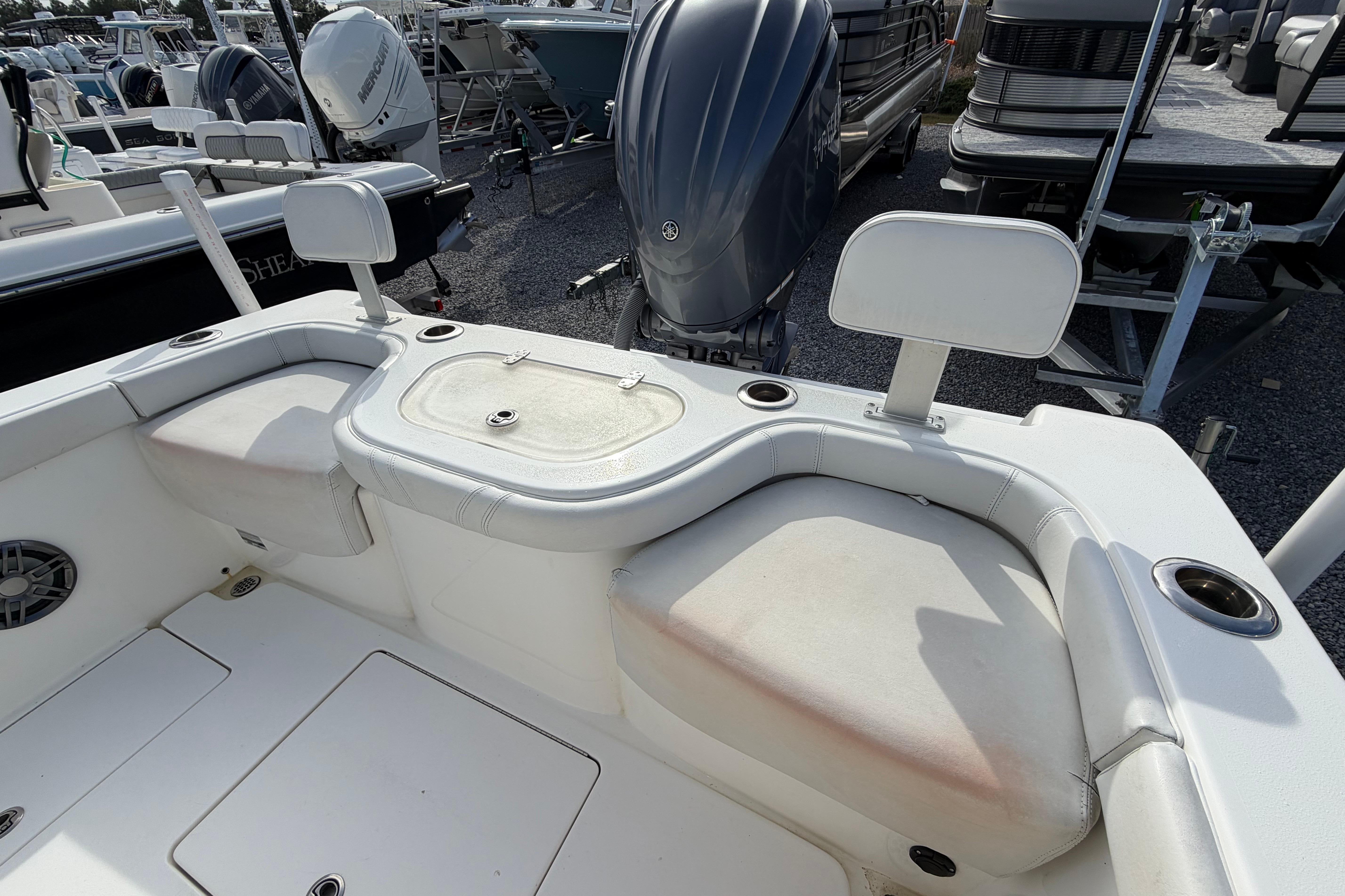 2023 Contender 24 Sport boat interior with seating and engine view.