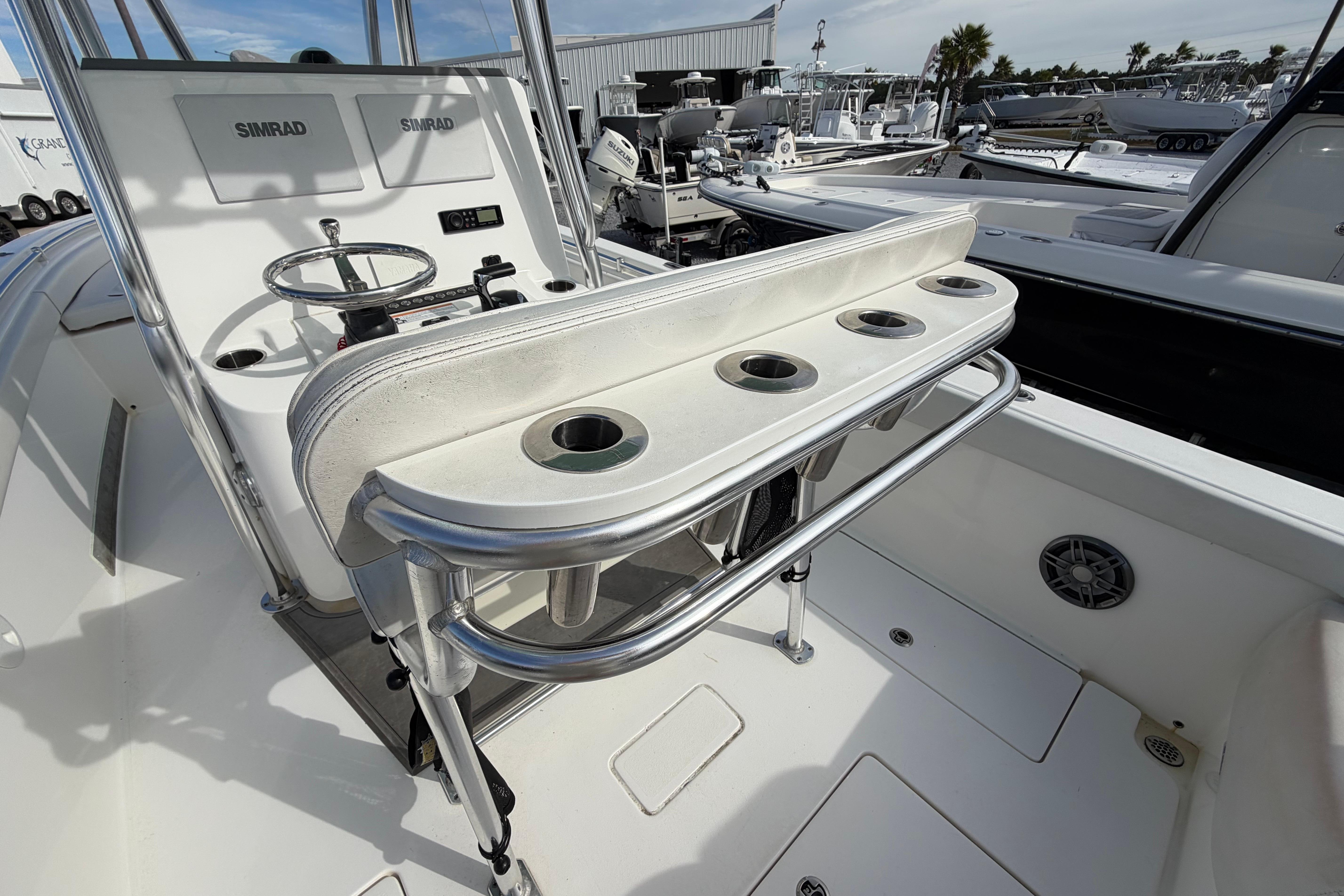 2023 Contender 24 Sport boat console with rod holders and Simrad electronics.