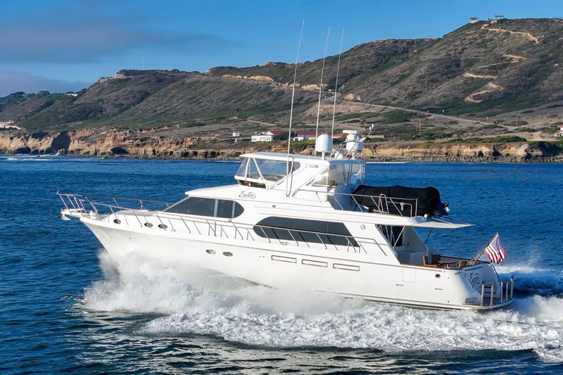 Encore Yacht Photos Pics 2006 Ocean Alexander 64 Pilothouse yacht cruising near scenic coastline.