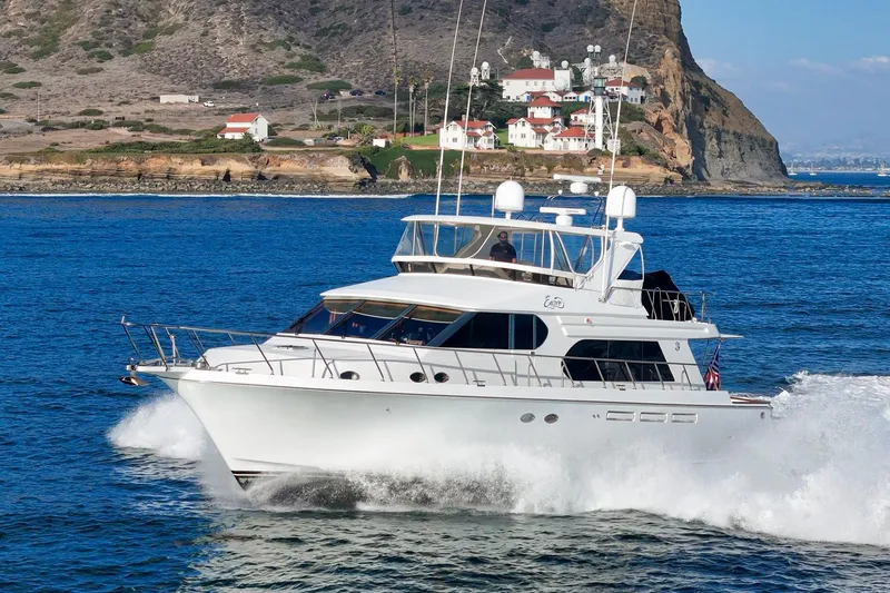 Encore Yacht Photos Pics 2006 Ocean Alexander 64 Pilothouse yacht cruising near rocky coastline.