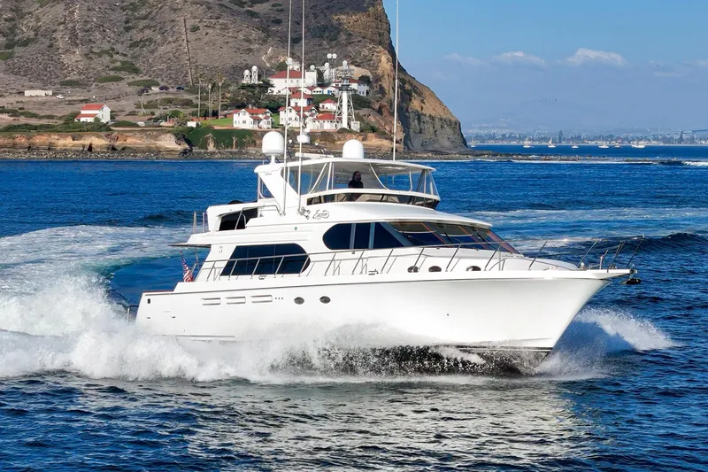 Encore Yacht Photos Pics Luxury 2006 Ocean Alexander 64 Pilothouse yacht cruising near scenic coastline.