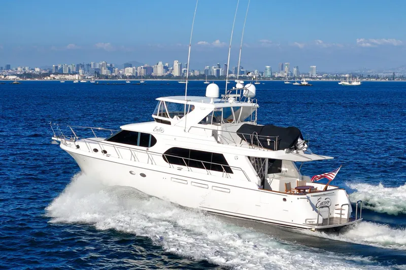 Encore Yacht Photos Pics 2006 Ocean Alexander 64 Pilothouse yacht cruising near city skyline.