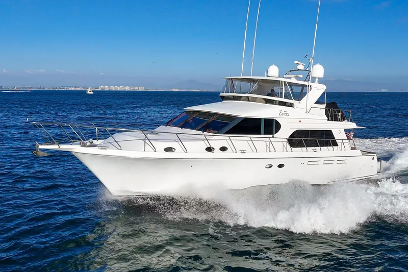 Encore Yacht Photos Pics 2006 Ocean Alexander 64 Pilothouse yacht cruising on open water under clear blue skies.