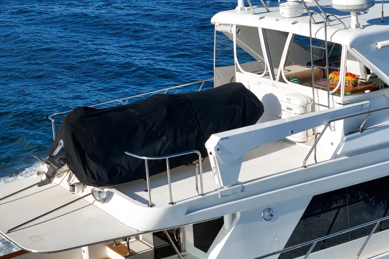 Encore Yacht Photos Pics 2006 Ocean Alexander 64 Pilothouse yacht with covered equipment on deck, cruising on blue waters.