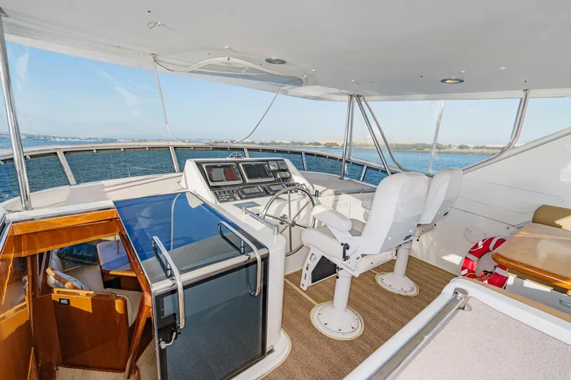 Encore Yacht Photos Pics Pilothouse of 2006 Ocean Alexander 64, featuring helm chairs and navigation equipment.