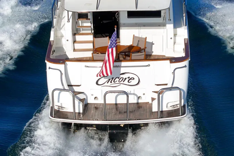 Encore Yacht Photos Pics 2006 Ocean Alexander 64 Pilothouse yacht cruising with American flag displayed.