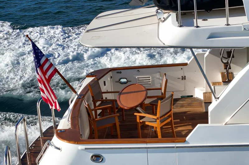 Encore Yacht Photos Pics 2006 Ocean Alexander 64 Pilothouse yacht with American flag and deck seating.