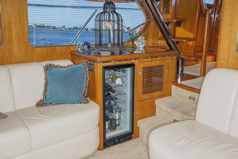 Encore Yacht Photos Pics Luxurious interior of 2006 Ocean Alexander 64 Pilothouse yacht with mini fridge and seating.
