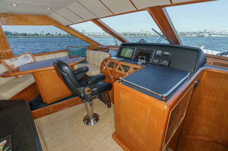 Encore Yacht Photos Pics Pilothouse interior of 2006 Ocean Alexander 64, featuring helm and seating area with ocean view.