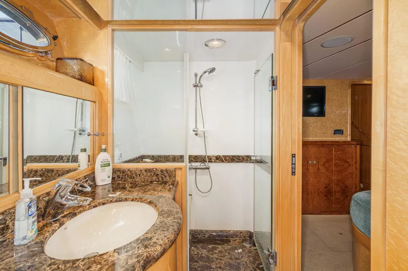 Encore Yacht Photos Pics Luxurious bathroom in 2006 Ocean Alexander 64 Pilothouse yacht with marble countertop and glass shower.