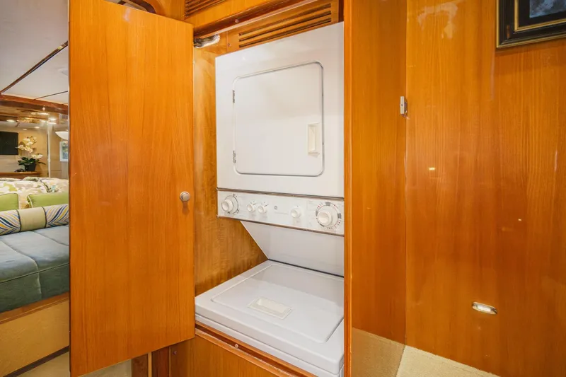 Encore Yacht Photos Pics Laundry area in 2006 Ocean Alexander 64 Pilothouse yacht with wood cabinetry.