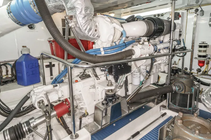 Encore Yacht Photos Pics Engine room of 2006 Ocean Alexander 64 Pilothouse yacht, featuring mechanical components and used oil container.