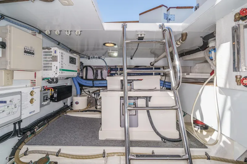 Encore Yacht Photos Pics Engine room of 2006 Ocean Alexander 64 Pilothouse yacht with equipment and ladder.