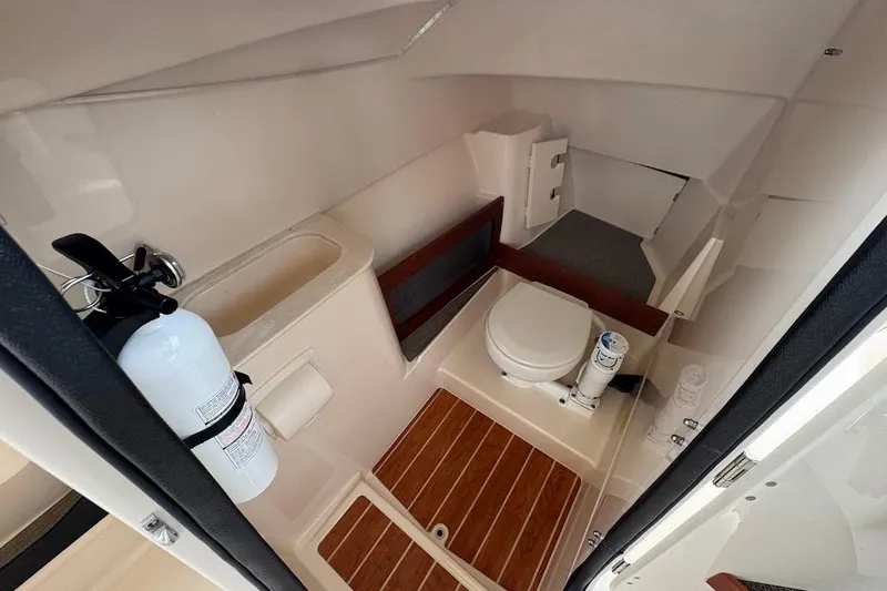  Yacht Photos Pics 2020 Grady-White Freedom 285 boat interior with toilet and fire extinguisher.