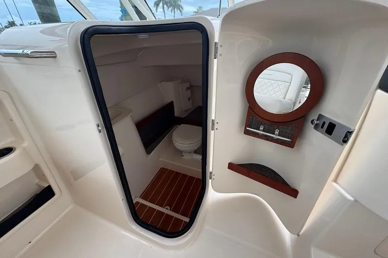  Yacht Photos Pics 2020 Grady-White Freedom 285 boat interior with a compact bathroom and mirror.