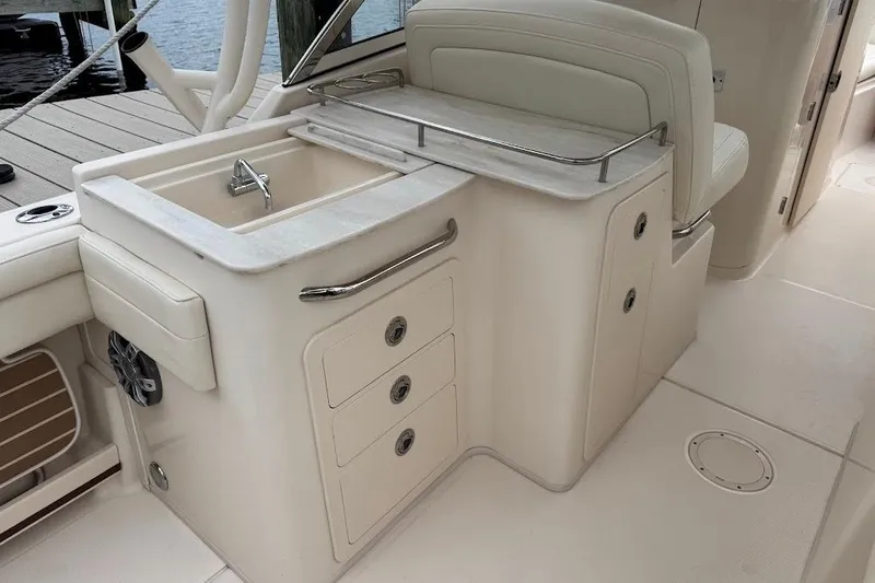  Yacht Photos Pics 2020 Grady-White Freedom 285 boat interior with sink and storage drawers.