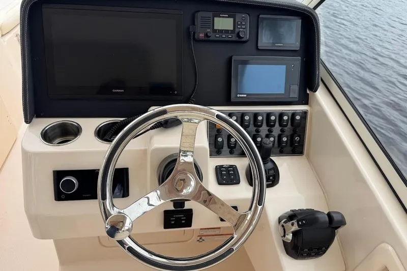  Yacht Photos Pics 2020 Grady-White Freedom 285 helm with steering wheel, controls, and navigation screens.