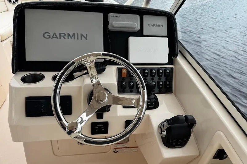  Yacht Photos Pics 2020 Grady-White Freedom 285 boat dashboard with Garmin navigation system and steering wheel.