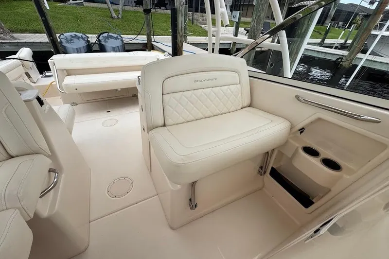  Yacht Photos Pics 2020 Grady-White Freedom 285 boat interior with cream seating and cup holders.