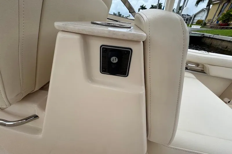 Yacht Photos Pics 2020 Grady-White Freedom 285 boat interior with beige seating and cup holder.