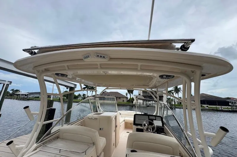  Yacht Photos Pics 2020 Grady-White Freedom 285 boat interior with helm, docked by waterfront homes.