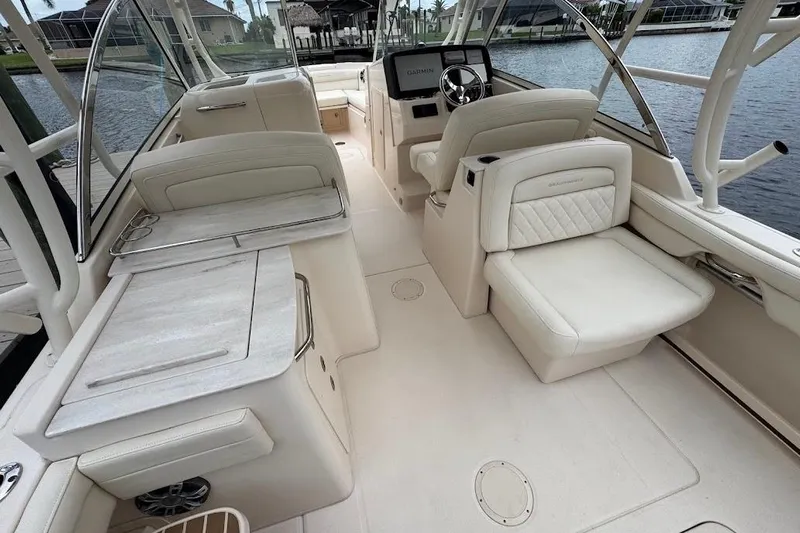  Yacht Photos Pics 2020 Grady-White Freedom 285 boat interior with luxurious seating and helm, dockside view.