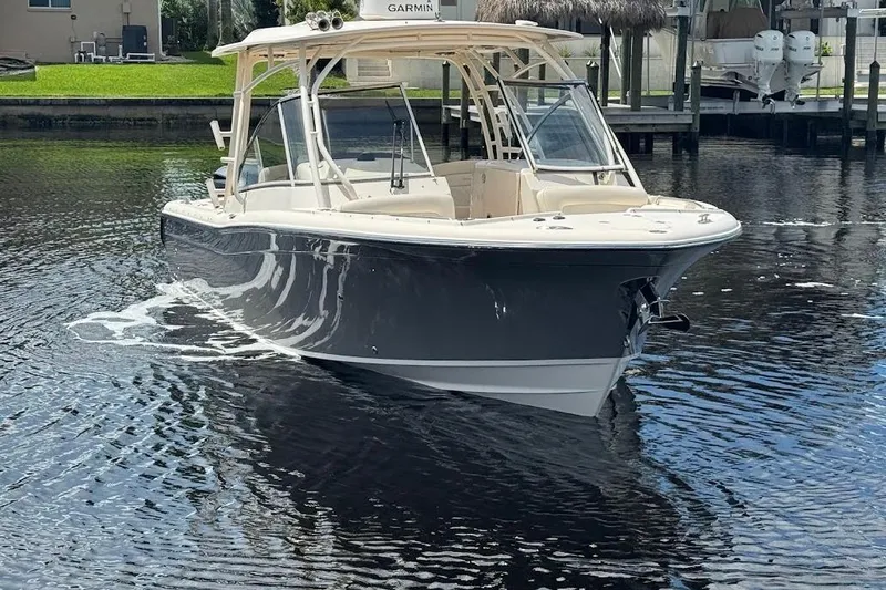  Yacht Photos Pics 2020 Grady-White Freedom 285 boat on calm water, featuring sleek design and modern amenities.